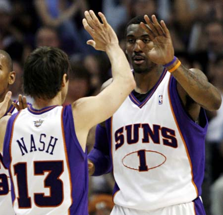 Phoenix Suns Steve Nash (13) high fives with Amare Stoudemire (1) after Stoudemire scored during third quarter NBA basketball action against the Golden State Warriors in Phoenix, Arizona, April 14, 2008. 