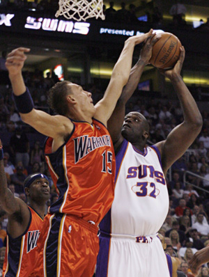 Golden State Warriors&apos; Andris Biedrins (15) tries to block a shot by Phoenix Suns&apos; Shaquille O&apos;Neal (32) during first quarter NBA basketball action in Phoenix, Arizona April 14, 2008.