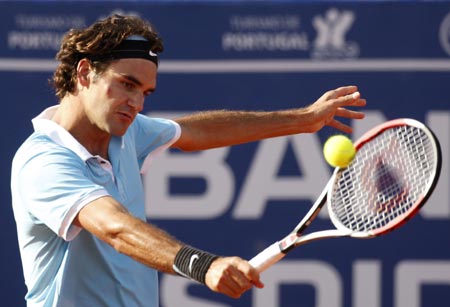 Roger Federer of Switzerland returns a shot to Olivier Rochus of Belgium during their tennis match at the Estoril Open in Lisbon April 15, 2008. 