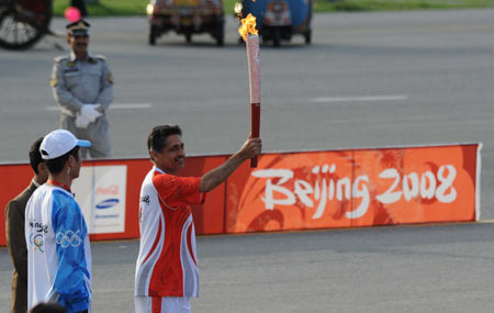 The first torchbearer Samiullah Khan displays the torch during the 2008 Beijing Olympic Games torch realy in Islamabad, capital of Pakistan, on April 16, 2008.