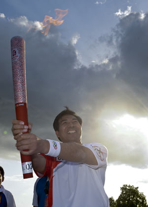 Torchbearer Luo Zhaohui, Chinese Ambassador to Pakistan, runs with the torch during the 2008 Beijing Olympic Games torch realy in Islamabad, capital of Pakistan, on April 16, 2008.