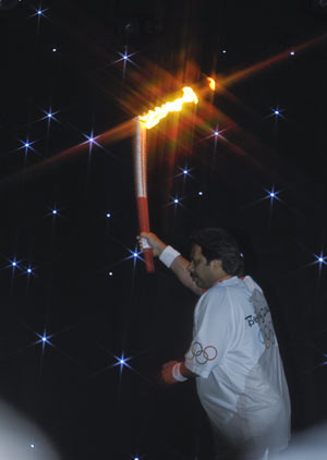 Torchbearer Hasan Sardar runs with the torch during the 2008 Beijing Olympic Games torch realy in Islamabad, capital of Pakistan, on April 16, 2008. 