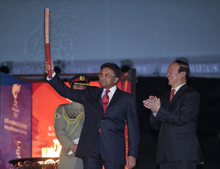 Pakistani President Pervez Musharraf (L) displays the torch as Jiang Xiaoyu, vice president of the Beijing Organizing Committee of Olympic Games, applauds at the closing ceremony of the Olympic torch relay at the Pakistan Sports Complex in Islamabad, capital of Pakistan, on April 16, 2008. Islamabad is the tenth stop of the 2008 Beijing Olympic Games torch relay outside the Chinese mainland. (Xinhua/Qi Heng)