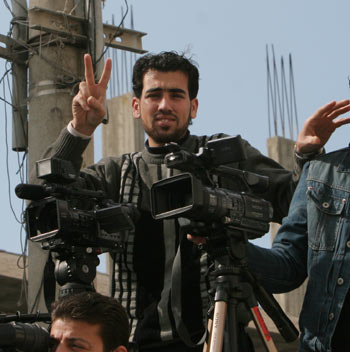 The undated file photo shows Reuters cameraman Fadel Shana working in Gaza. At least ten Palestinians including local cameraman Fadel Shana working for Reuters Television were killed in an Israeli airstrike Wednesday in central Gaza. (Xinhua/Wissam Nassar) 