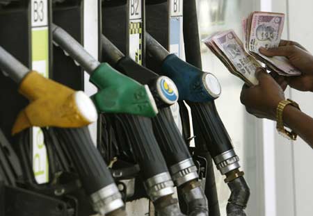 A worker counts Indian currency at a petrol pump in the northeastern Indian city of Siliguri in this file photo taken on Feb. 5, 2008. Crude oil for May delivery on Wednesday closed at nearly 115 dollars a barrel, the third straight day of records, on supply concerns on the New York Mercantile Exchange. 