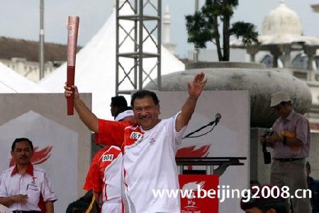 Photo: OCM president, the first torchbearer in Kuala Lumpur, holds Olympic torch