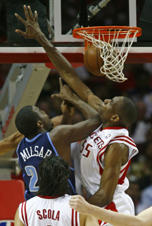 Houston Rockets center Dikembe Mutombo (R) blocks the shot of Utah Jazz forward Ronnie Millsap during the first half of Game 2 of their NBA basketball playoff series in Houston April 21, 2008. 