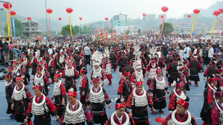 People of Miao ethnic group perform folk dance in Taijiang County of southwest China's Guizhou Province, April 20, 2008.