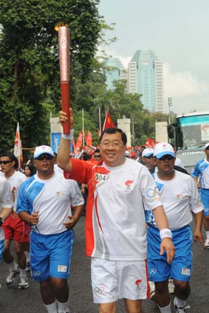 Torchbearer Abdul Alex Soelistyo runs with the torch in Jakarta, capital of Indonesia, on April 22, 2008. Jakarta is the 14th stop of the 2008 Beijing Olympic Games torch relay.