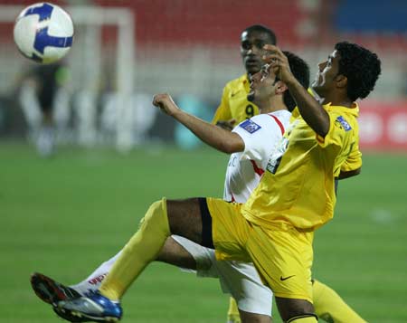 Kuwait's Al-Kuwait club player Khaled A.Al awadhi(L) fights for the ball with Emirates Al-Wasl club player Abdulla(R) during their AFC Champions League football match in Kuwait City, April 23, 2008. 