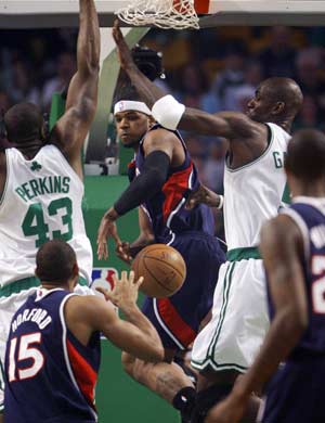 Atlanta Hawks forward Josh Smith (C) passes the ball back to Hawks center Al Horford (15) between the defense of Boston Celtics center Kendrick Perkins (43) and Celtics forward Kevin Garnett (R) in the first quarter of Game 2 of their NBA basketball playoff series in Boston, Massachusetts April 23, 2008. 