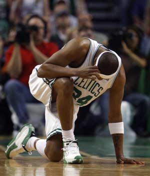 Boston Celtics forward Paul Pierce crouches down after taking a hard foul from Atlanta Hawks guard Joe Johnson during the first quarter of Game 2 of their NBA basketball playoff series in Boston, Massachusetts April 23, 2008. 