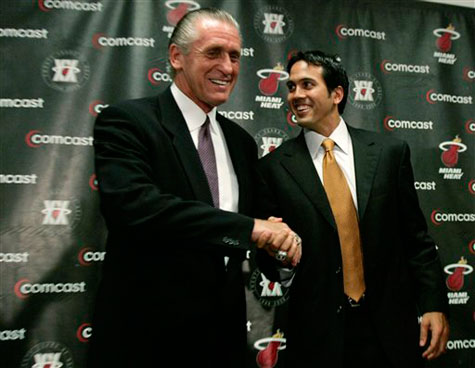 Newly named Miami Heat head coach Erik Spoelstra, right, shakes hands with former coach Pat Riley, left, following a news conference in Miami yesterday. Riley stepped down as coach and will remain as president of the Heat. Spoelstra, a 37-year-old assistant will become the NBA's youngest current coach. 