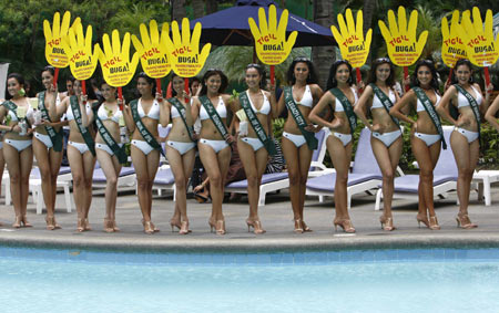 Contestants for the upcoming Miss Philippines Earth 2008 pageant hold signs encouraging motorists to cut emissions as they are presented to the media at a hotel in Manila April 29, 2008. 
