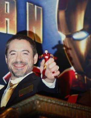 Actor Robert Downey Jr. (R) poses for photographers before ringing the opening bell at the New York Stock Exchange, April 29, 2008. U.S. stocks trimmed losses and were little changed on Tuesday after a report showed a stronger-than-expected reading of consumer confidence for April. Downey is the star of the new Marvel Comics movie 'Iron Man' opening May 2.