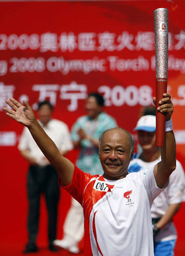 Photo: First torchbearer Zheng Wentai runs with the Olympic torch