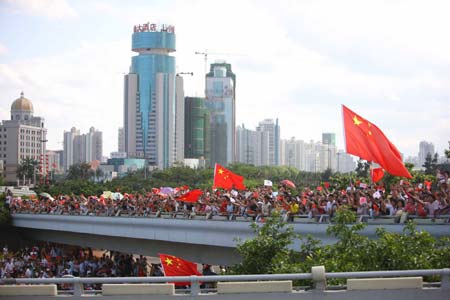 People cheer for the 2008 Beijing Olympic Games torch relay in Haikou, capital of south China's Hainan Province, on May 6, 2008.
