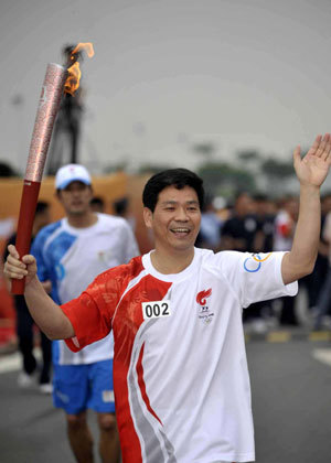 Torchbearer Liu Jiangnan runs with the torch during the 2008 Beijing Olympic Games torch relay in the southern Chinese city of Guangzhou Wednesday morning, May 7, 2008.