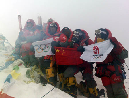 Chinese climbers display an Olympic torch, an Olympic flame lantern, a flag of International Olympic Committee, a Chinese National flag and a flag of the 29th Olympic Games at the top of the 8844.43-meter summit of Mt. Qomolangma in southwest China's Tibet Autonomous Region on May 8, 2008. 