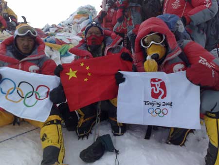 Chinese climbers display flags at the top of the 8844.43-meter summit of Mt. Qomolangma in southwest China's Tibet Autonomous Region on May 8, 2008.