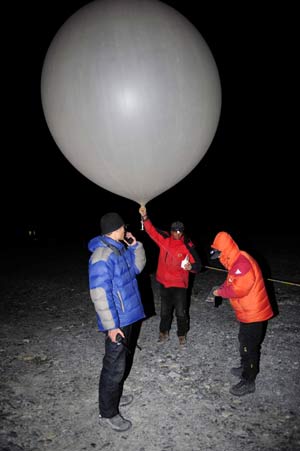 Three Chinese meteorological observers check the weather with a balloon at the Base Camp of Mt. Qomolangma, at the altitude of 5,200 meters in southwest China&apos;s Tibet Autonomous Region on May 8, 2008. 