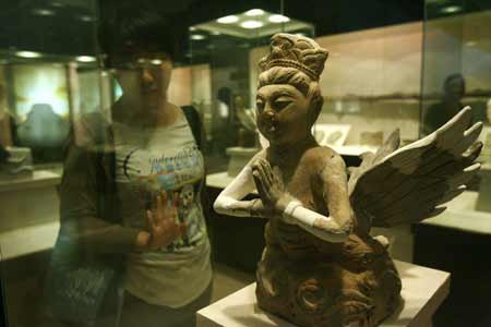 A tourist views a cultural relic at the Western Xia Museum near the Imperial Tombs of the Western Xia Kingdom (1038-1227), in Yinchuan, capital of northwest China