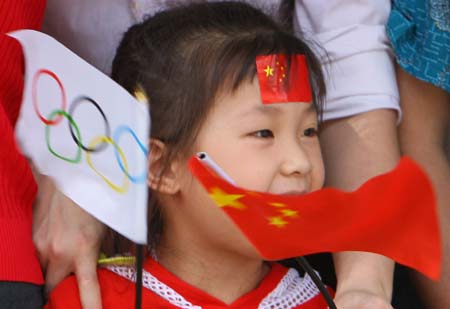 A girl cheer for the 2008 Beijing Olympic Games torch relay in Huizhou, south China's Guangdong Province, on May 9, 2008. 