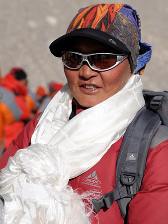 Gyigyi, one of the two female climbers of the Chinese Mountaineering Team, smiles as she returns with her team to the Base Camp of Mt. Qomolangma, at the altitude of 5,200 meters, in southwest China's Tibet Autonomous Region on May 9, 2008. 