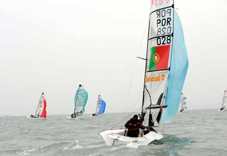 Sailboats compete during the SKUD18 competition at the 2008 International Association for Disabled Sailing (IFDS) Qingdao International Regatta in Qingdao, east China's Shandong Province, May 11, 2008.