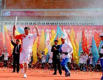 Torchbearer Wang Jiasheng from Quanzhou sport bureau runs with the torch during the 2008 Beijing Olympic Games torch relay in Quanzhou, southeast China's Fujian Province, on May 12, 2008.(Xinhua/Zhang Guojun)