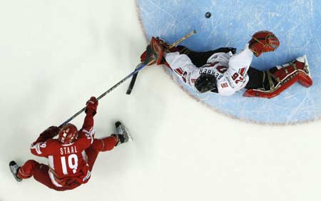 Denmark's Kim Staal (L) scores a penalty shot goal on Switzerland's goalie Martin Gerber during the third period of action at the 2008 IIHF World Hockey Championships in Quebec City, May 11, 2008.