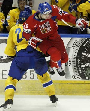 Czech Republic's Jakub Klepis (R) jumps in the air as he is hit by Sweden's Jonas Frogren during the third period of action at the 2008 IIHF World Hockey Championships in Quebec City, May 11, 2008. 