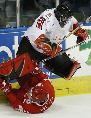 Denmark's Thor Dresler (bottom) collides with Switzerland's goaltender Martin Gerber during the second period of action at the 2008 IIHF World Hockey Championships in Quebec City, May 11, 2008.