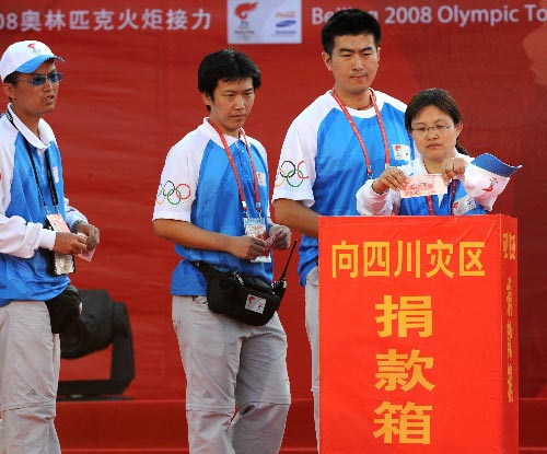 Olympic torch relay staff members donate money to the quake-hit areas