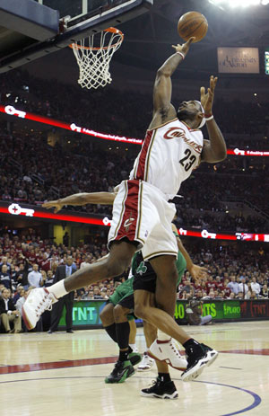 Cleveland Cavaliers LeBron James (23) shoots with his back almost to the basket after getting tangled up with Boston Celtics Ray Allen during the first half of Game 4 of their NBA Eastern Conference semi-final basketball series in Cleveland, Ohio, May 12, 2008.
