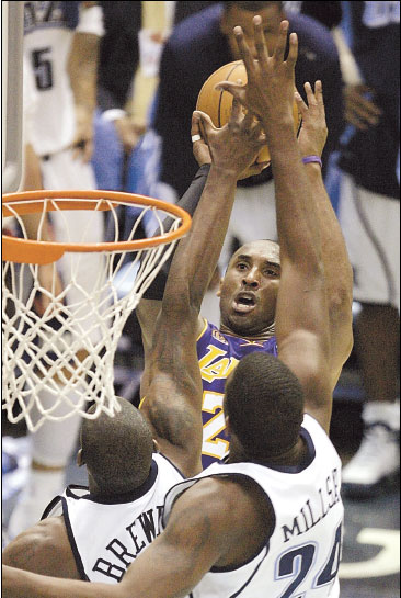 Los Angeles Lakers guard Kobe Bryant is double teamed by Utah Jazz's Ronnie Brewer (left) and Paul Millsap as he shoots during Game 6 of their Western Conference semifinal series in Salt Lake City, Utah, on Friday.