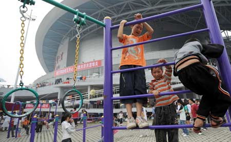 Children play outside the Jiuzhou Stadium in Mianyang City, southwest China's Sichuan Province, May 17, 2008. 