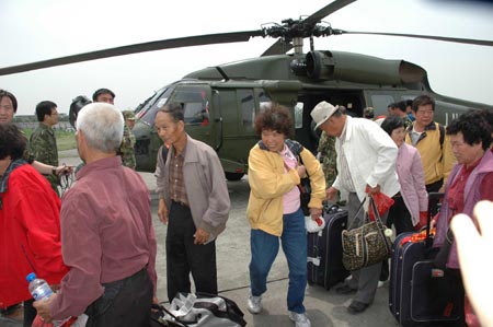 Eleven of the 14 elderly Taiwan tourists, who had been stuck in Qipangou Village close to the epicenter of Wenchuan County after the Monday magnitude 8 earthquake, had arrived at a military airport in Chengdu at Sunday noon aboard a helicopter.