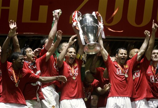 Manchester United players celebrate with the trophy after winning the Champions League final soccer match at the Luzhniki Stadium in Moscow. United beat Chelsea 6-5 on penalties after the match eneded 1-1 after extra time.