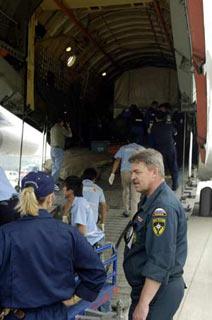 Members of Russian medical team unload relief materials from a chartered plane carrying a Russian medical team in Chengdu, capital of the quake-hit Sichuan province, May 20, 2008. Along with the team arrived a mobile hospital, vehicles and relief materials. Another 36-tonnes of humanitarian assistance materials from Russia will arrive in the city on Tuesday afternoon including medicines weighing 7 tonnes. (Xinhua Photo)