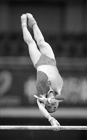 He Kexin of China performs during the uneven bars event at the World Cup in Tianjin on May 15. 