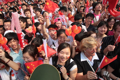 People cheer during the Olympic torch relay in Shanghai this morning. The Olympic flame arrived in Shanghai last night after the relay was suspended for three days to mourn victims of the Sichuan earthquake.