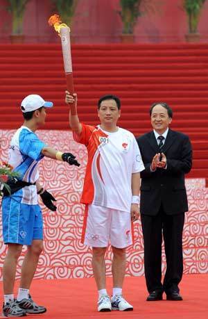 The Beijing Olympic torch relay kicks off in Nanjing, the capital city of Jiangsu Province on Tuesday May 27, 2008. The first torchbearer Yang Yang(C) holds the torch at the beginning of the relay.