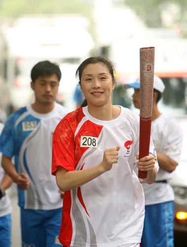 Photo: Torchbearer Sun Yue runs with Olympic torch