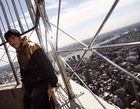 Liu Xiang, Chinese track and field star and Olympic gold medallist, poses at the top of the Empire State Building in New York May 28, 2008.
