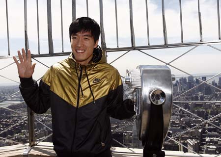 Liu Xiang, Chinese track and field star and Olympic gold medallist, waves during a news conference at the top of the Empire State Building in New York May 28, 2008. Xiang will be competing in Saturday's Reebok Grand Prix track & field meet at the Icahn Stadium on Randall's Island in New York.