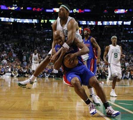 Boston Celtics Paul Pierce (behind) collides with Detroit Pistons Chauncey Billups during third quarter 