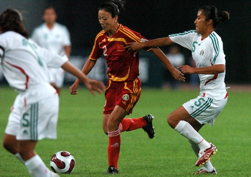 Chinese women's soccer team competes with their German counterparts during the Good Luck Beijing International Women's Football Tournament in Shenyang Olympic Stadium.