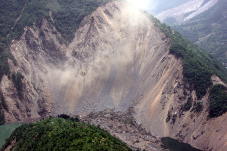 An aerial photo taken on May 28, 2008 shows a landslide near the Tangjiashan earthquake-induced lake near Beichuan County in southwest China's Sichuan Province. The earthquake-induced lake is at risk of bursting and threatens thousands of people downstream. Some 30 excavators are working non-stop to dig a diversion channel to drain the lake, which is expected to complete within 5 to 7 days if weather permits. A large number of residents in Mianyang City are prepared to evacuate.