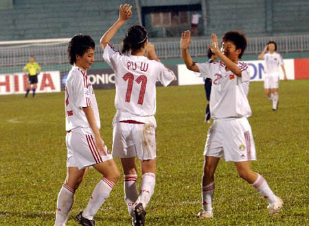 Chinese football player Pu Wei(C) celebrates score with teammate. Defending champions China and former winner Democratic People's Republic of Korea (DPRK) secured berths to semi-finals of the final round of the 2008 Women's Asian Football Championship after beating Thailand 5-1, and hosts Vietnam 3-0, respectively, in Vietnam's southern Ho Chi Minh City on Friday.
